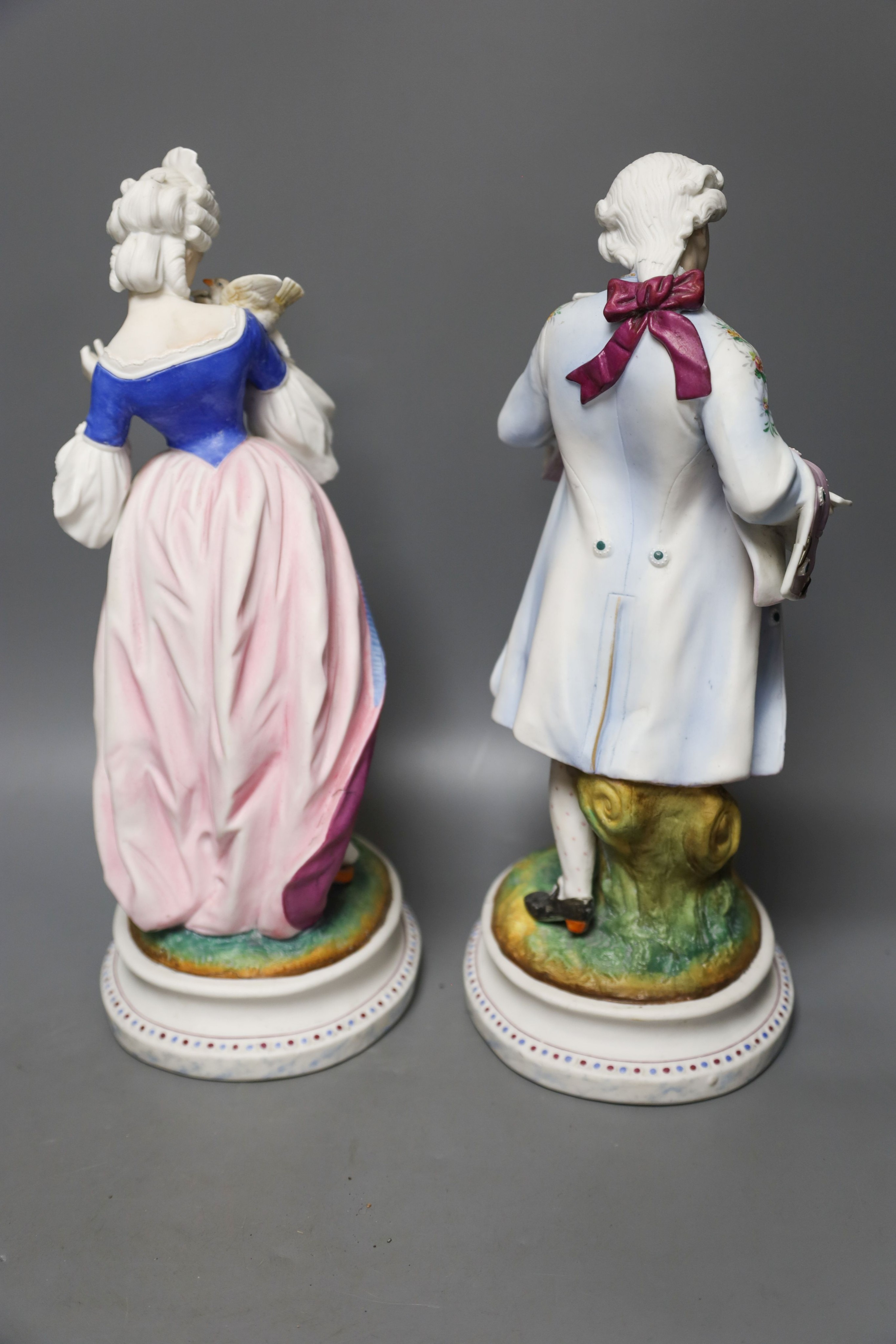 A pair of 19th century French bisque figures of a lady and gentleman 37cm